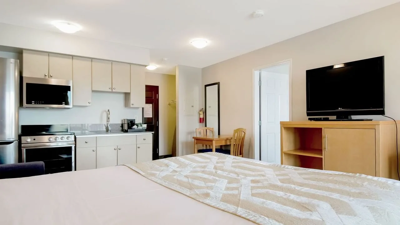 One-bedroom hotel suite with a king bed and living space