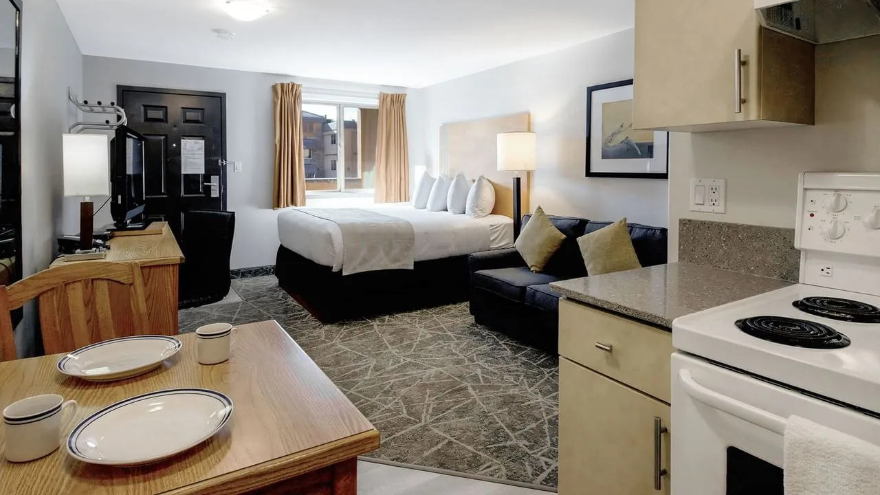 Hotel room with a queen bed and kitchen area