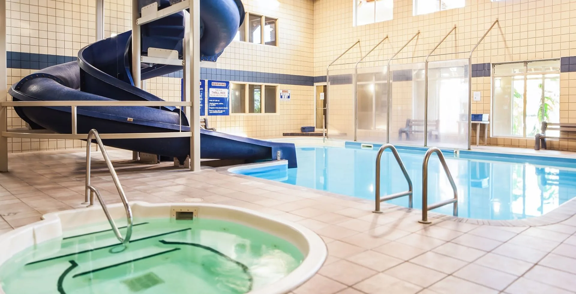 Indoor pool, blue waterslide and hot tub